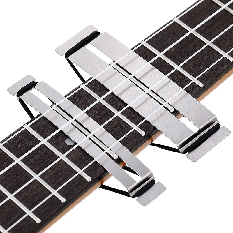 Stainless steel guitar fingerboard guards with rubber bands, ideal for fretboard protection during fret dressing and maintenance.